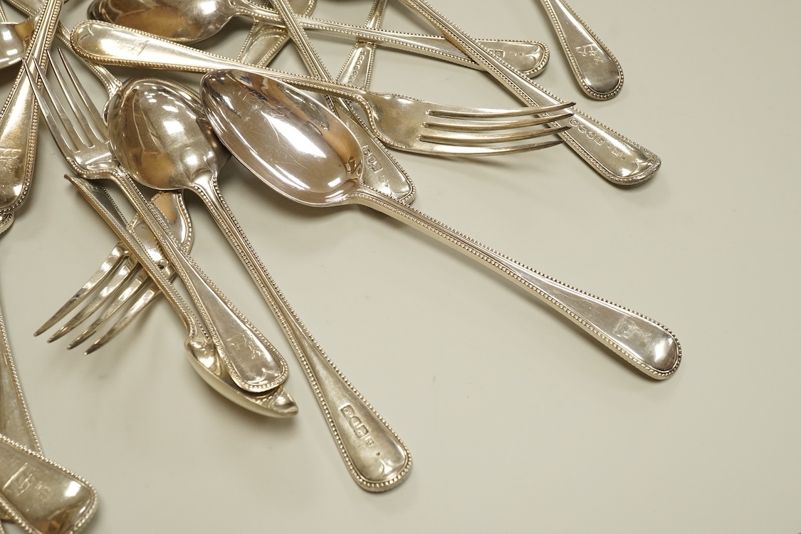 A harlequin part canteen of late Victorian and Edwardian silver beaded Old English pattern flatware, various dates and makers, comprising thirty items, 55.8oz.